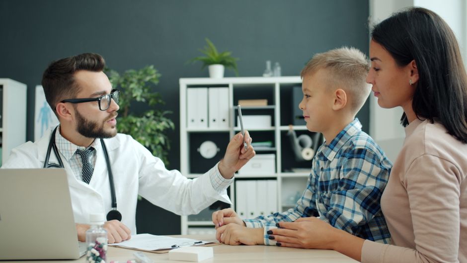 Rodzic omawia z pediatrą informacje o opiece nad noworodkiem
